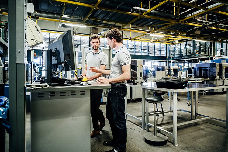 Action reflex : Two Engineers Working At Console Together